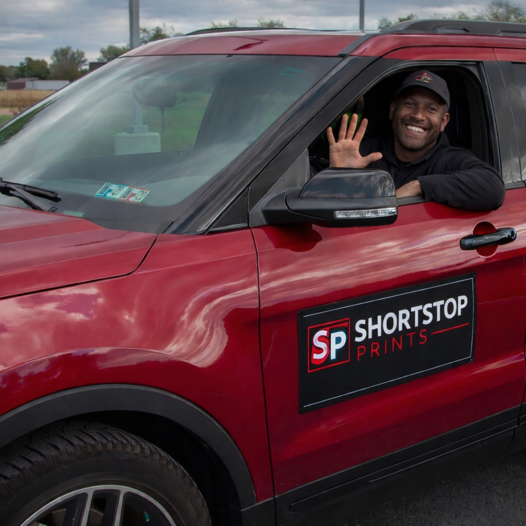 man waving with car magnets